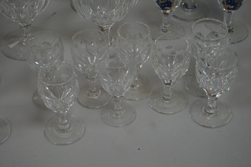 A suite of Thomas Webb Crystal wine glasses, Royal Yacht pattern, including two decanters, eight goblets, white wines and clarets, sixty-four pieces. Condition - mostly good